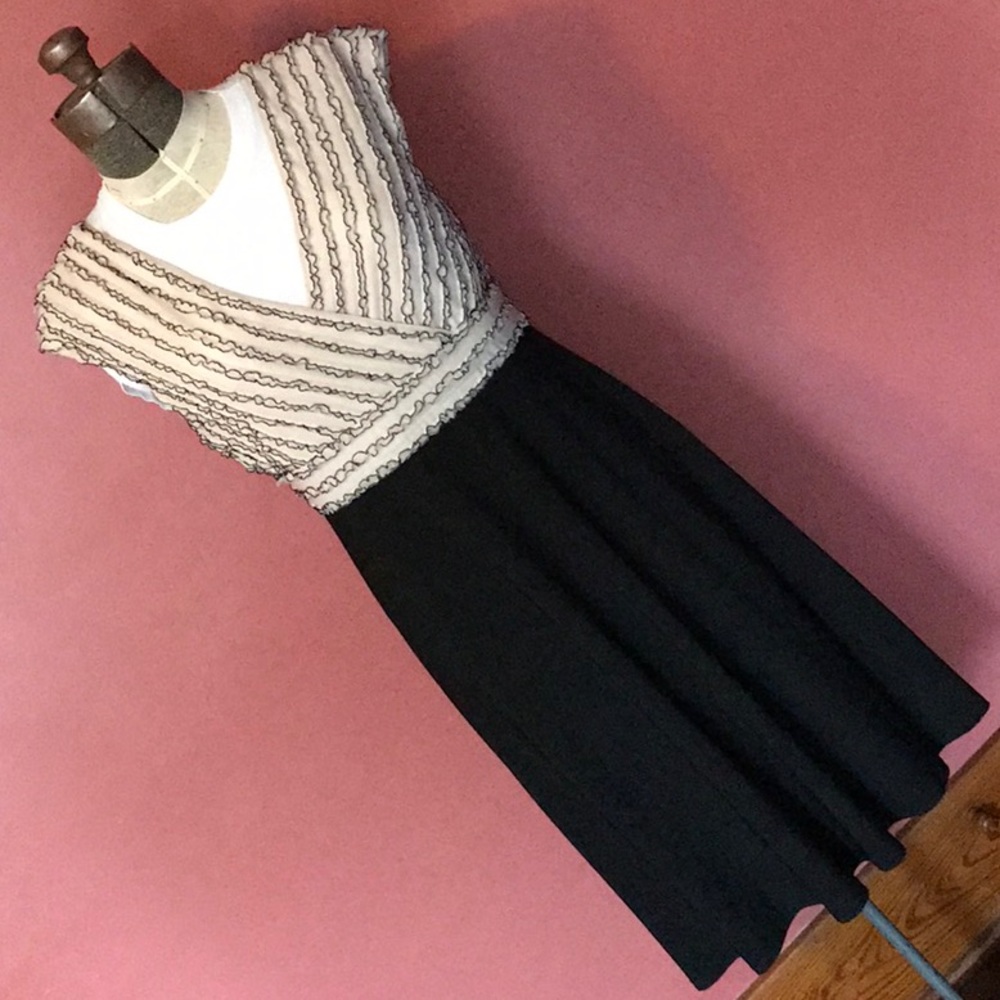 Ivory and black ruffle dress. Very flattering!